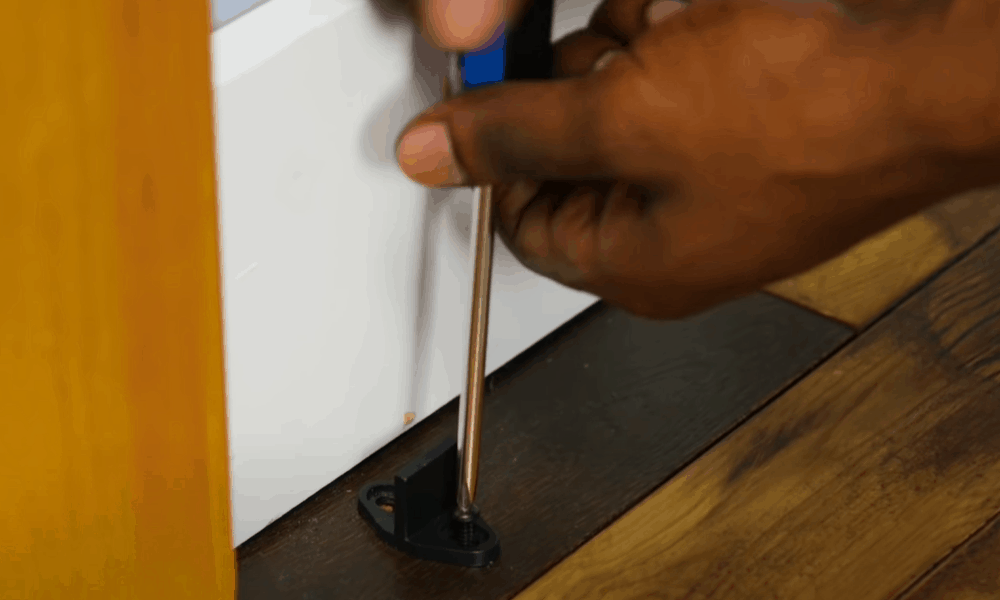 Install floor-mounted door guide