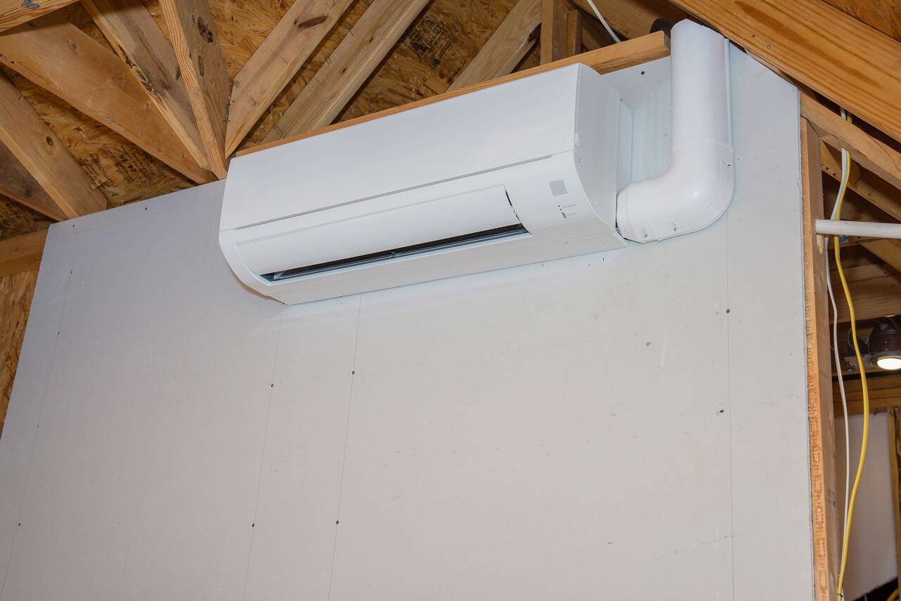 Use a mini split air conditioner on the garage wall instead